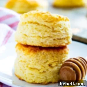 Two Tupelo Honey Ginormous Biscuits stacked on a plate.