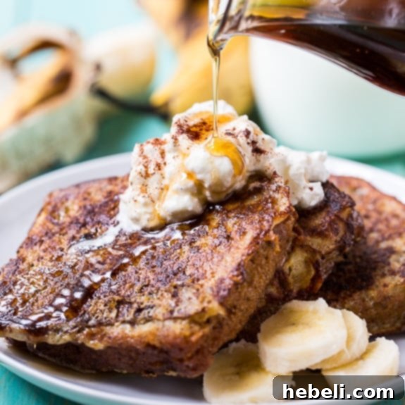 Slices of White Chocolate Banana Bread French Toast drizzled with maple syrup