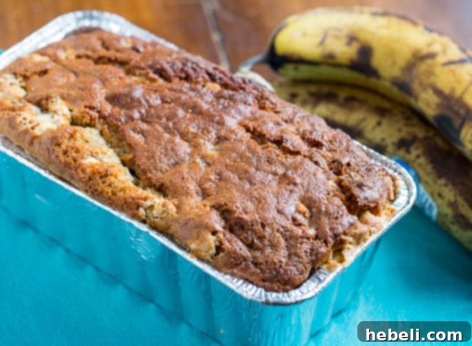 A plate of White Chocolate Banana Bread French Toast with a dollop of whipped cream