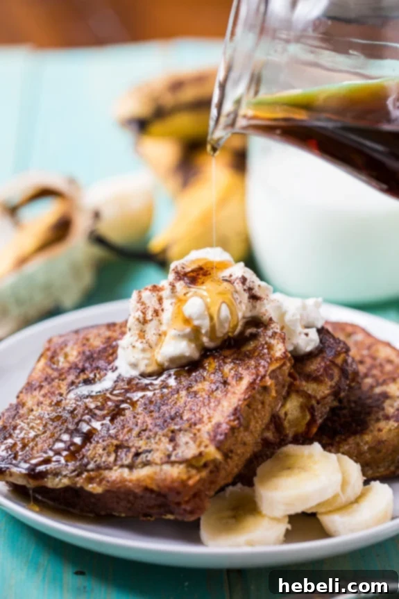 White Chocolate Banana Bread French Toast ready to be served, with syrup and cream