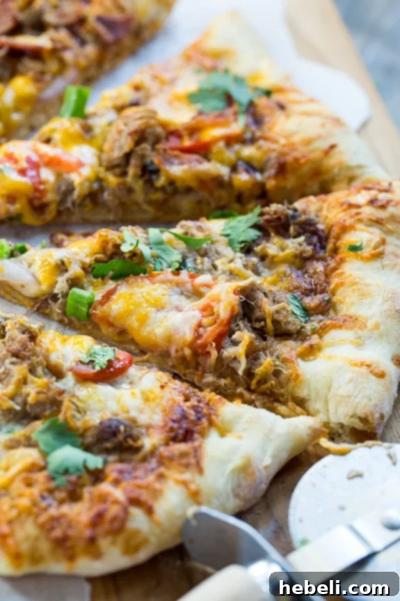 Close-up of pulled pork, bacon, and red onion, primary toppings for the BBQ pizza.