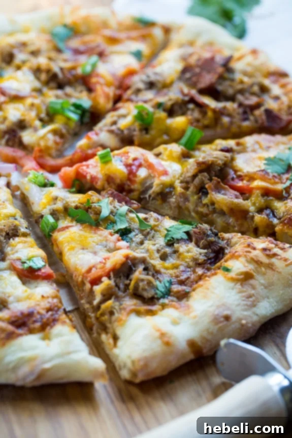 Assembling the Southern BBQ Pizza, with all toppings layered on the dough.