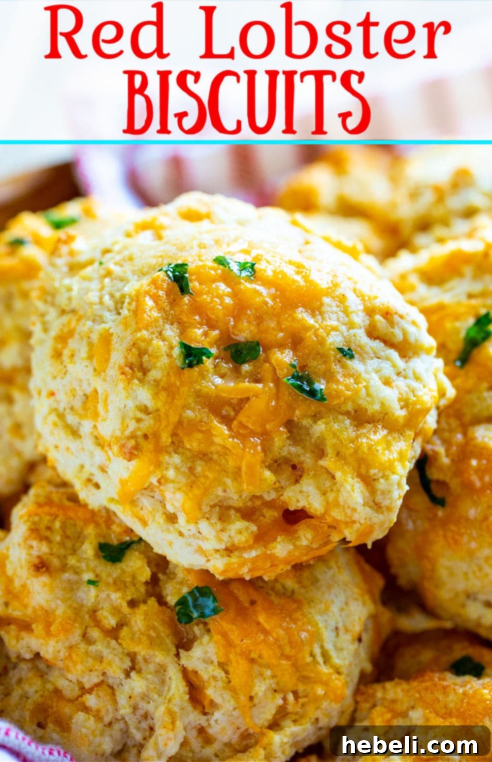 Close-up of a perfectly baked, fluffy, and cheesy Red Lobster Biscuit, showcasing its golden crust, garlic butter topping, and subtle parsley flecks.