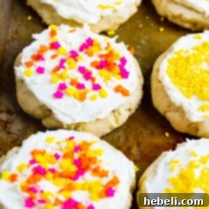 Lofthouse-Style Cookies covered in sprinkles on a baking sheet.