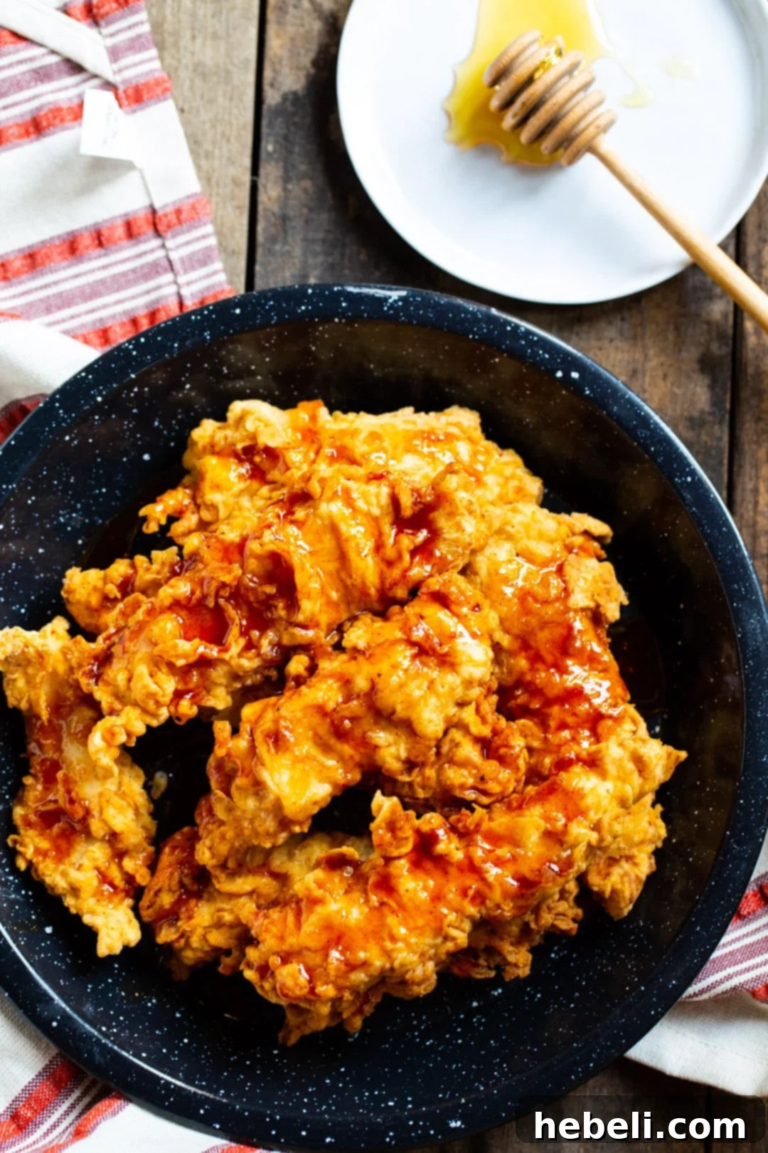 Platter of Honey Chipotle Chicken Crispers with a small bowl of honey on the side.