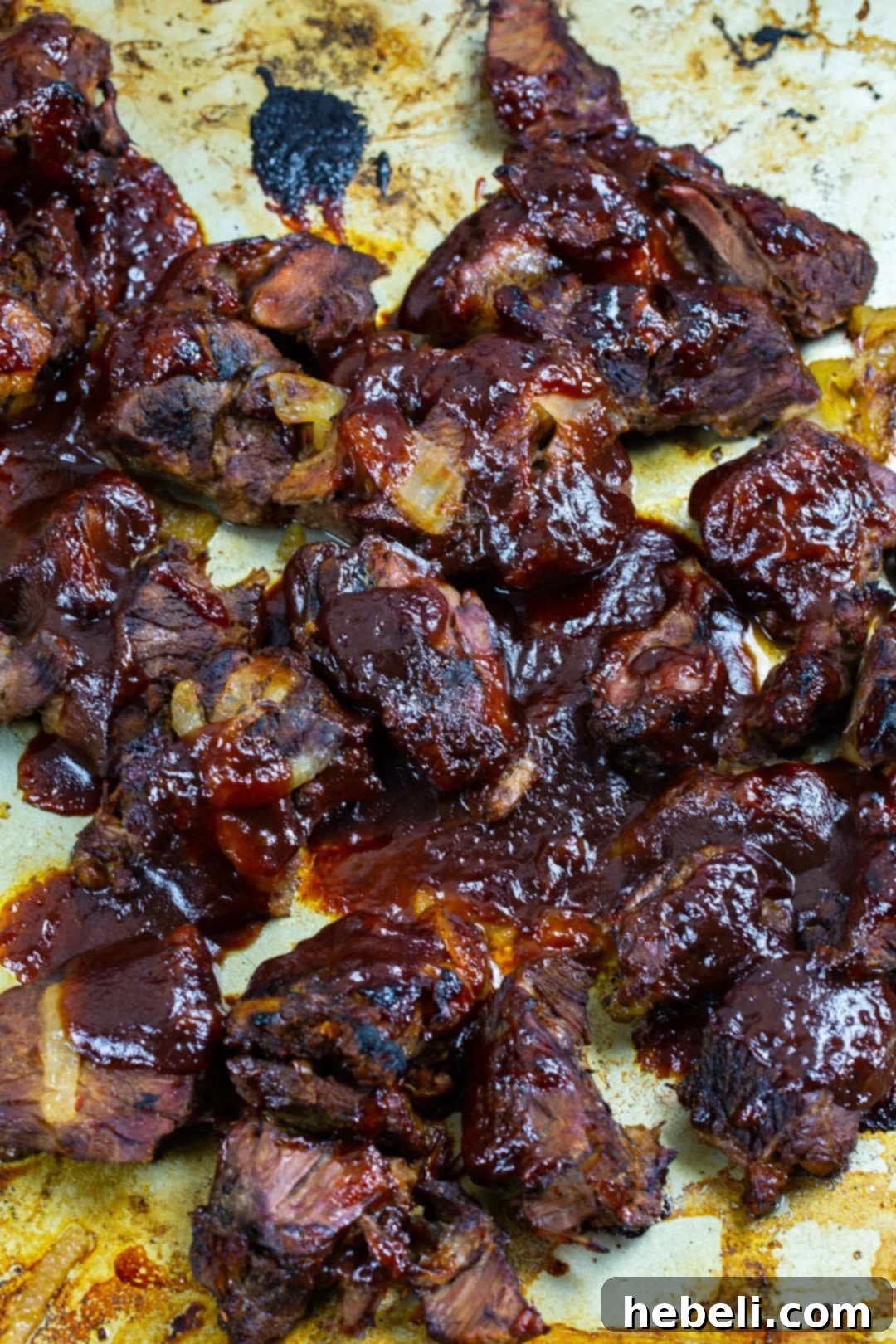 Slow-Cooker BBQ Beef 4 Close-up of broiled beef chunks, showcasing the caramelized BBQ sauce.