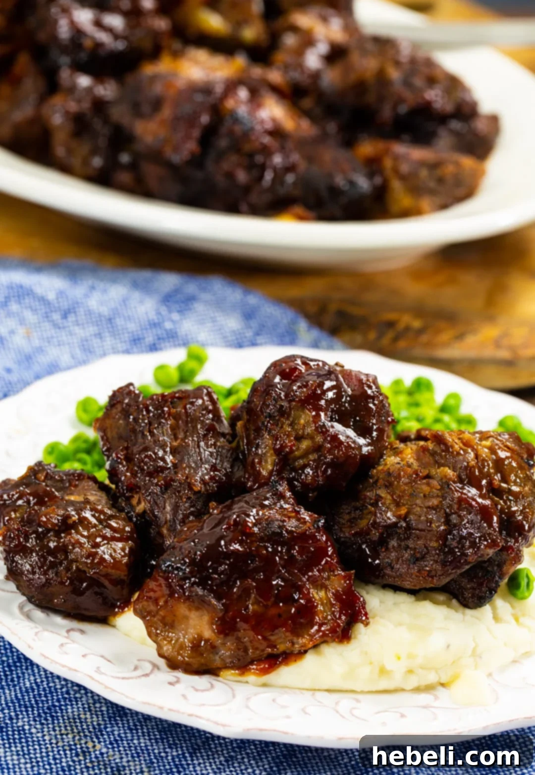 Slow-Cooker BBQ Beef 6 BBQ Pot Roast served over creamy mashed potatoes.