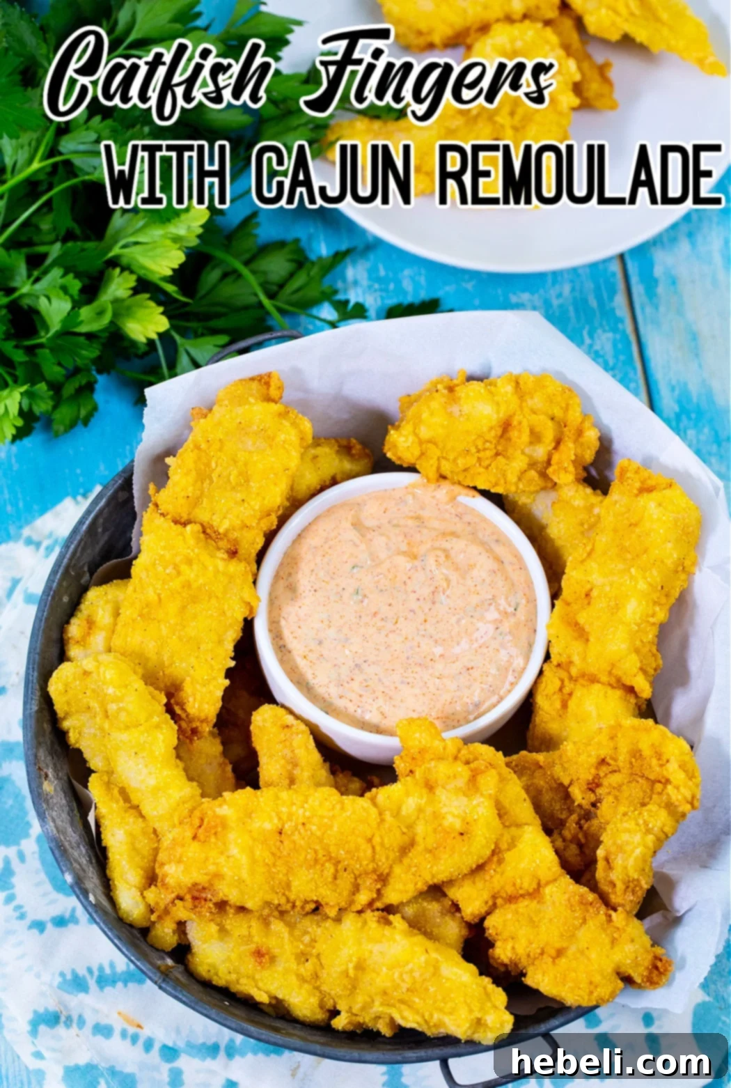 Fried catfish fingers served in a rustic basket with a small bowl of remoulade.