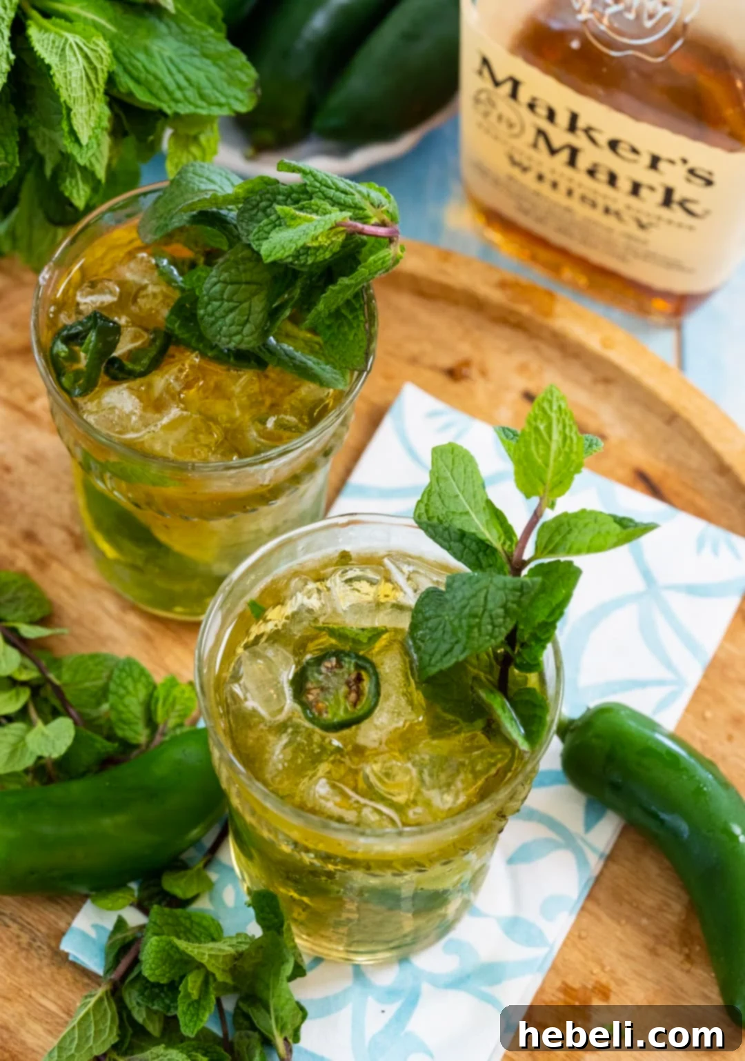 Southern Fire Julep 4 Two glasses of finished Jalapeno Mint Juleps, mounded with crushed ice and garnished with fresh mint.