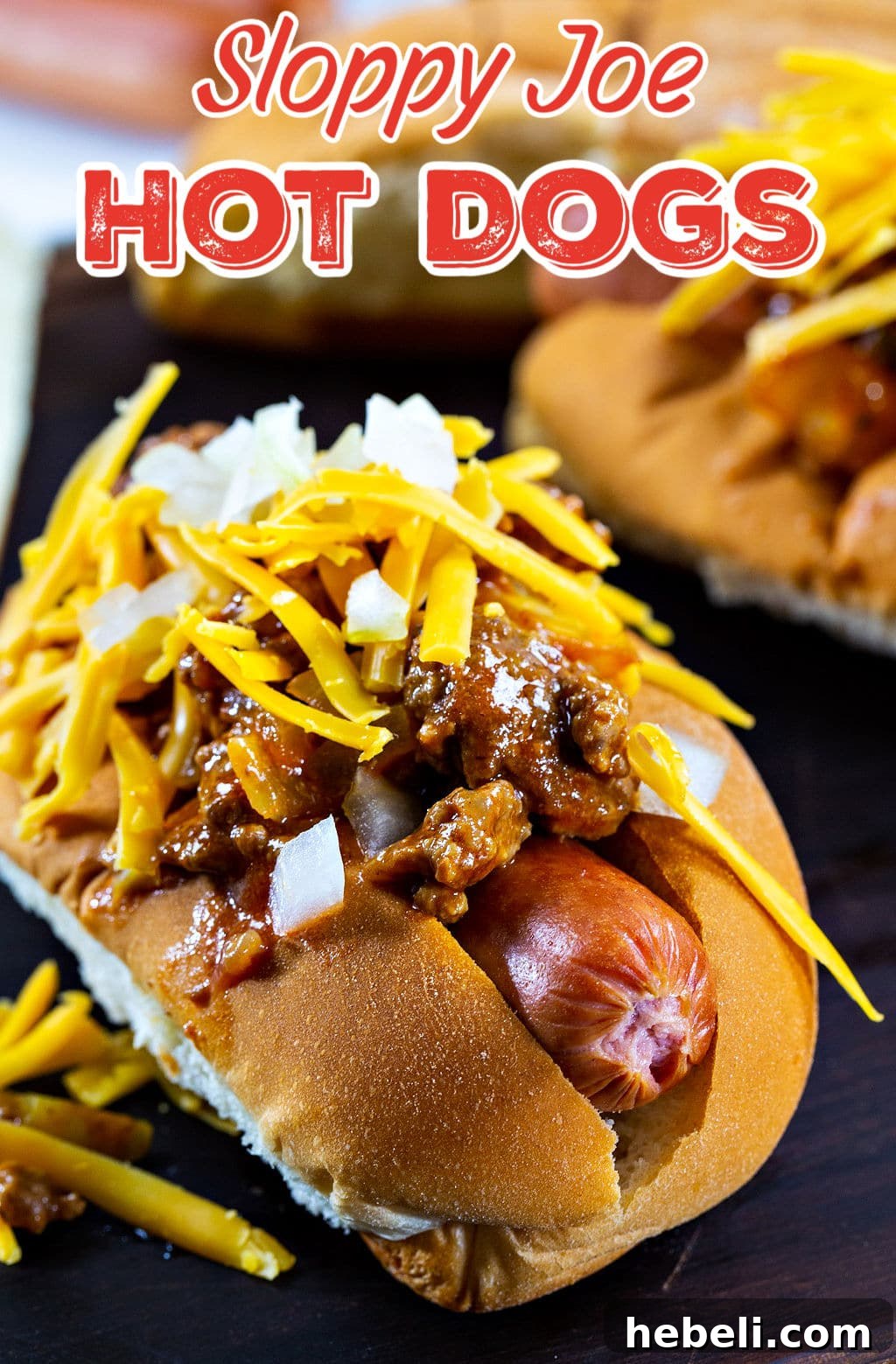 Sloppy Joe Hot Dog Recipe with Tangy Tomato Sauce 5 Sloppy Joe Hot Dog topped with shredded cheddar cheese and onion.