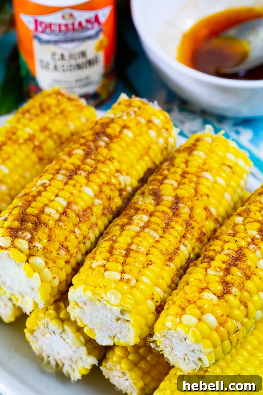 Spicy Cajun Buttered Corn Recipe 4 Cajun Buttered Corn piled up on plate.