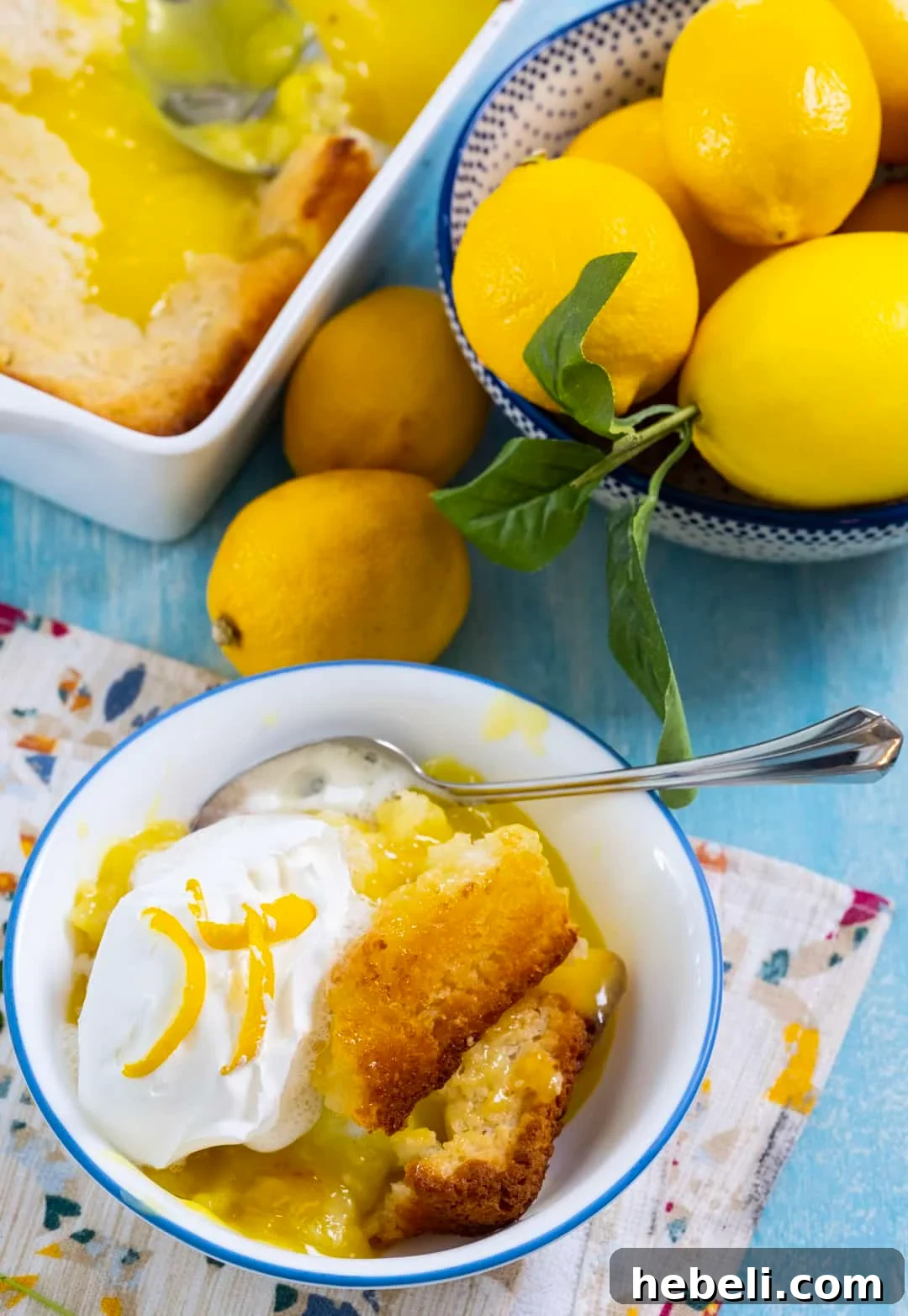 Warm Lemon Cobbler with Buttery Crust 4 Lemon Cobbler topped with whipped cream in a bowl.