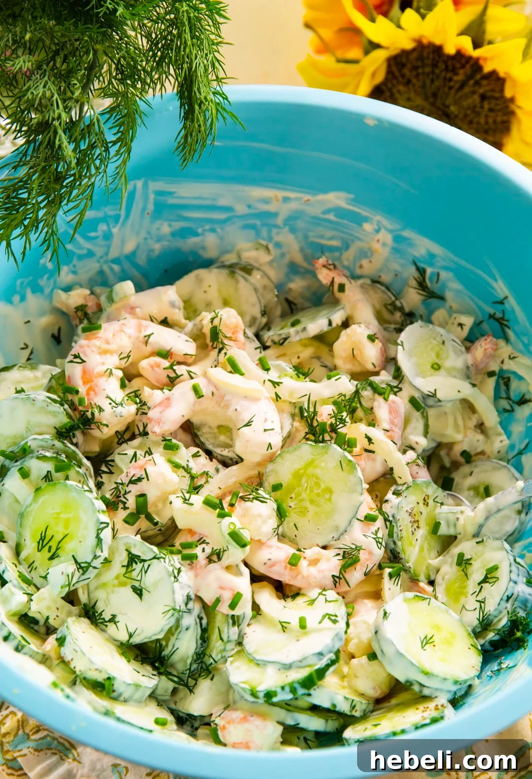 Refreshing Shrimp and Cucumber Salad with Zesty Dressing 3 Shrimp salad in a large blue mixing bowl.