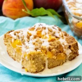 Slice of Peach Crisp Coffee Cake on a white plate