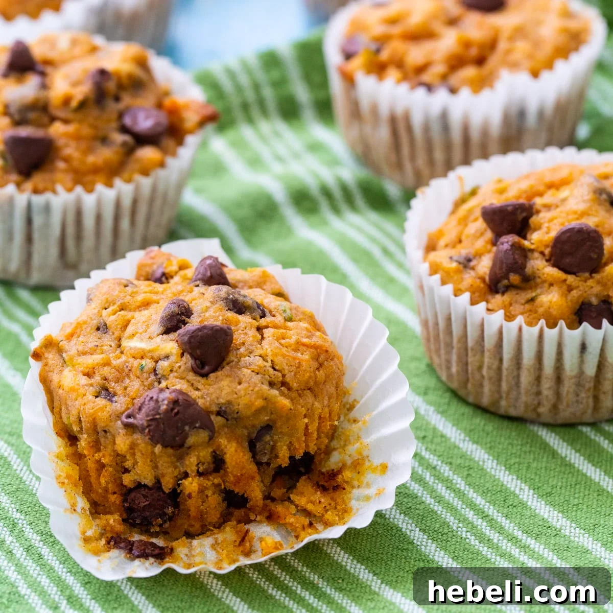 Sweet Potato Zucchini Muffins on a green and white tea towel.