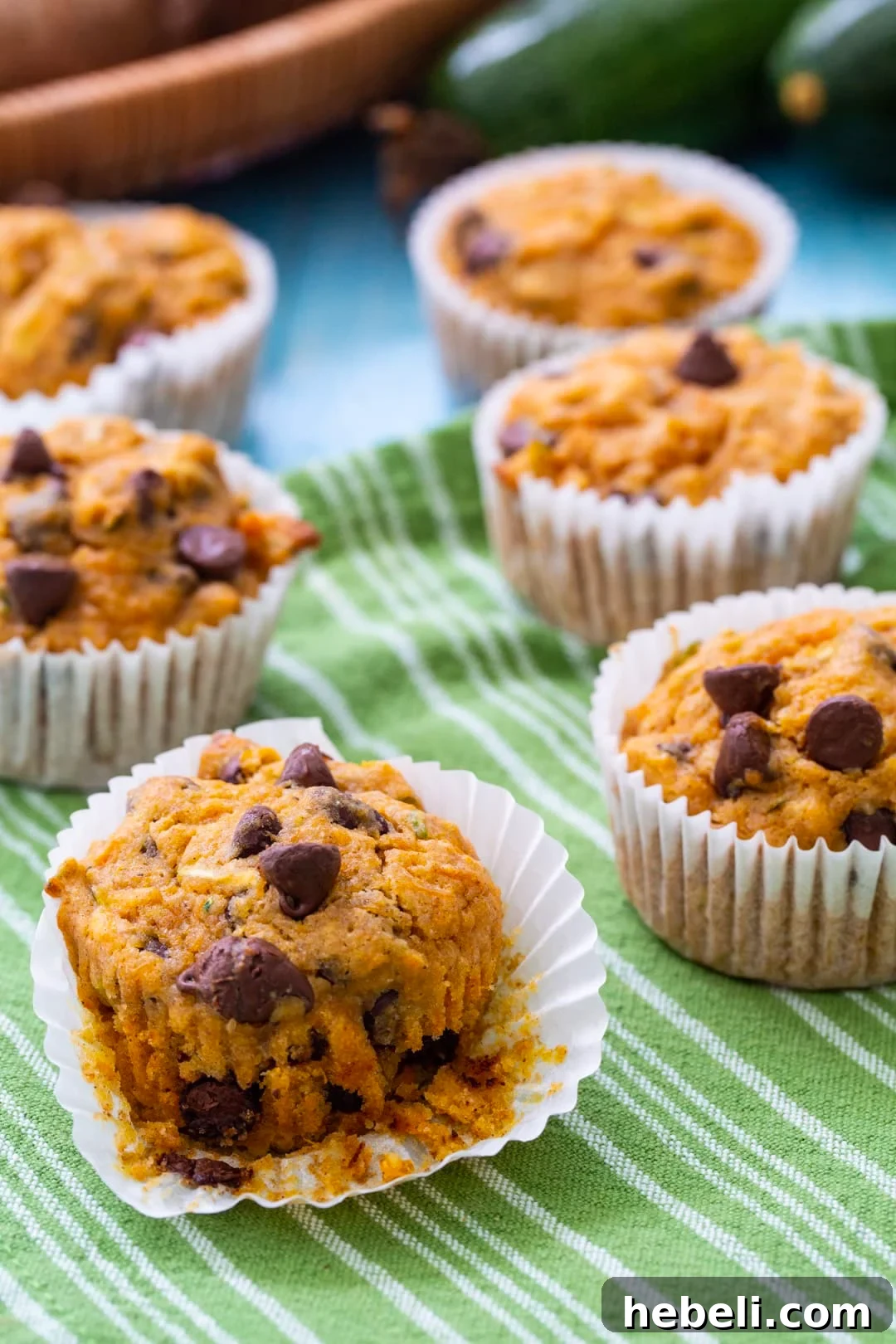 Sweet Potato Zucchini Muffins on a green and white tea towel.