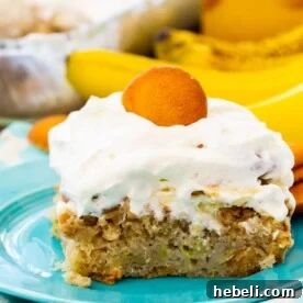 Slice of Banana Pudding Poke Cake on blue plate.